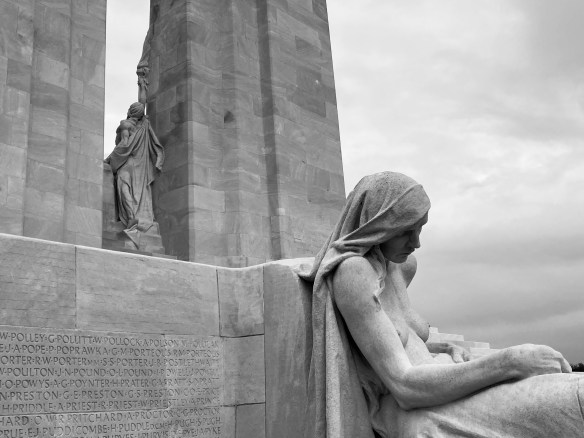 Close-up of a war memorial at Vimy Ridge with statue of a seated, grieving woman